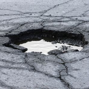 hole on road with puddle